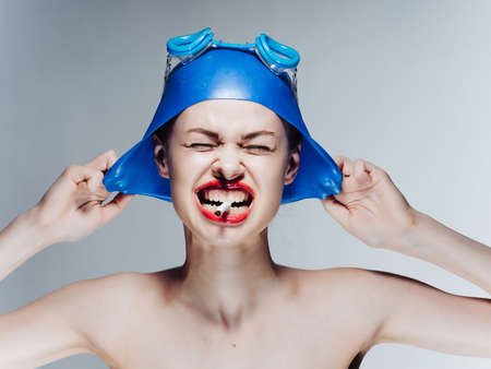 woman athlete with bare shoulders red lips smokes a cigarette Professional