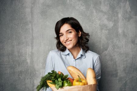 pretty woman in blue shirt package with groceries in supermarket food dietの写真素材