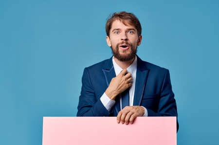 businessmen pink mockup poster in hand blue background