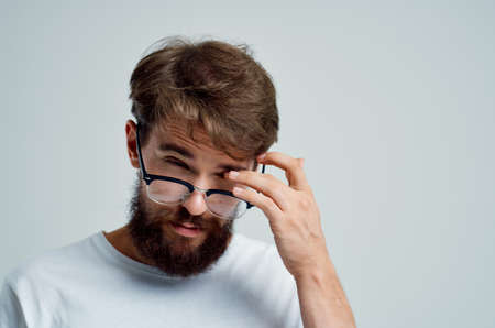bearded man with poor eyesight health problems close-upの写真素材