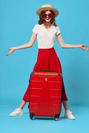 woman tourist red suitcase vacation fun sunglasses travelの写真素材
