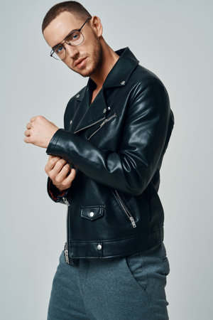 handsome man wearing glasses short hair leather jacket posing fashion