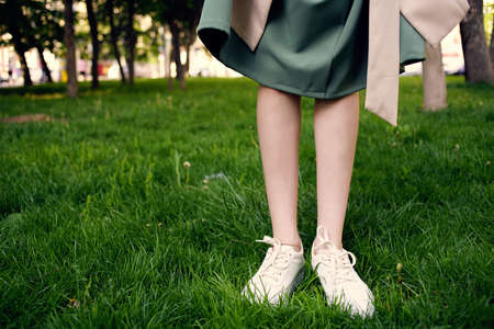 female feet on the lawn walk in the park outdoorsの写真素材