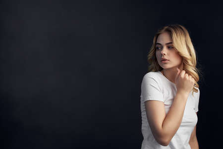 blonde White T-shirt fashion Lifestyle dark backgroundの写真素材