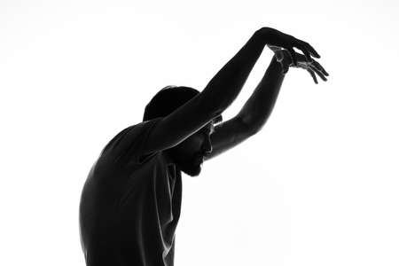 man gesturing with his hands silhouette light background anonymityの写真素材