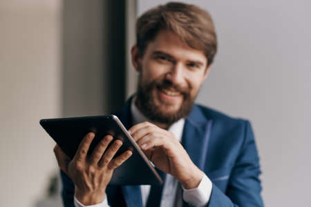 business man in a suit with a tablet in the hands of a technology managerの写真素材