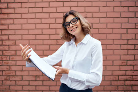Business woman documents office work professional brick wall