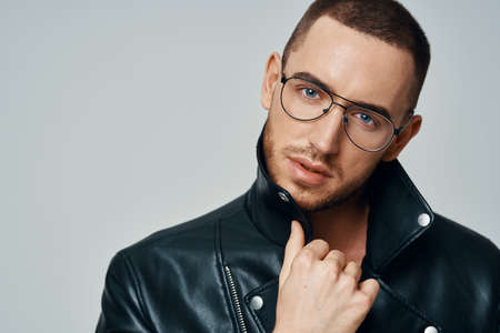 man in black leather jacket topless posing modern style self-confidenceの写真素材