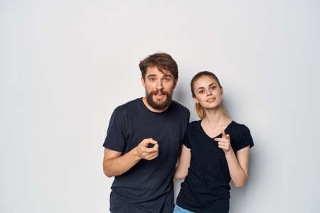 fashionable man and woman in black t-shirt sunglasses posing isolated backgroundの写真素材