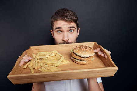 bearded man with hamburger fast food close-up lifestyleの写真素材