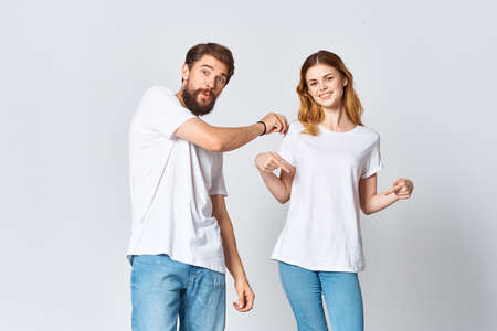man and woman in white t-shirts studio fashion posingの写真素材