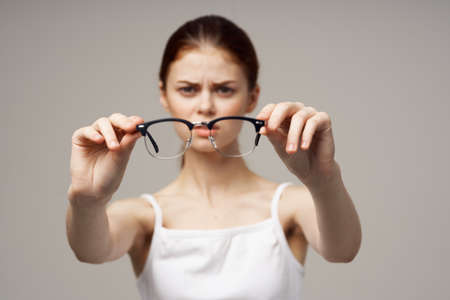woman glasses in the hands of astigmatism studio treatmentの写真素材
