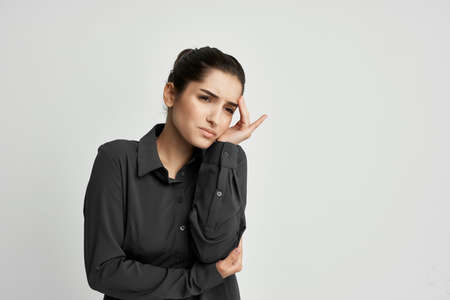 brunette holding his head depressed light backgroundの写真素材