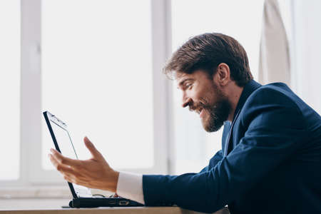 manager sitting at a desk in front of a laptop finance network technologies