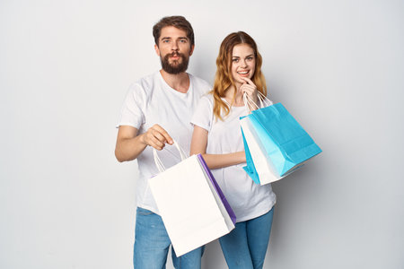 young couple in white t-shirts shopping funの写真素材