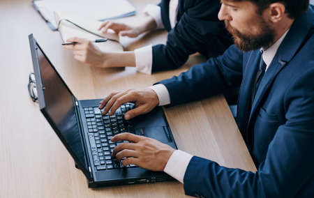 managers in the office in front of a laptop career network technologiesの写真素材