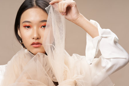 asian woman in transparent fabric model stylish clothes makeupの写真素材