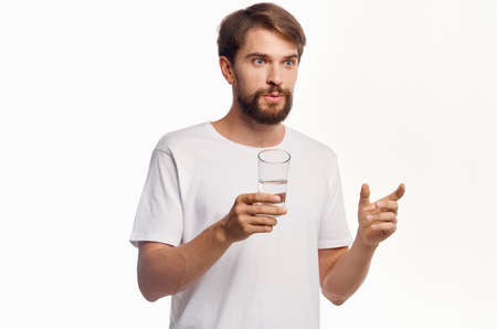 handsome man drinking water isolated backgroundの写真素材