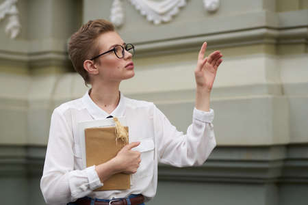 pretty woman with a book in his hands outdoors reading education