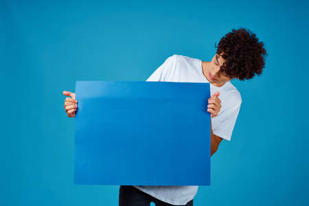 guy holding a blue mockup Poster copy-space studioの写真素材