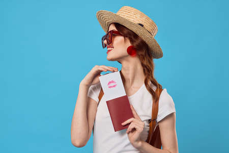 woman in red skirt passport and plane tickets vacation travel flightの写真素材