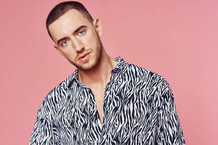 fashionable man shirt posing self confidence pink backgroundの写真素材