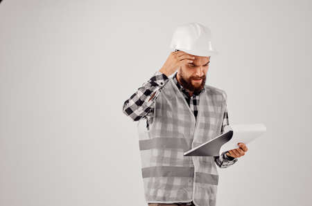 male builder in a white helmet blueprints Professional isolated backgroundの写真素材