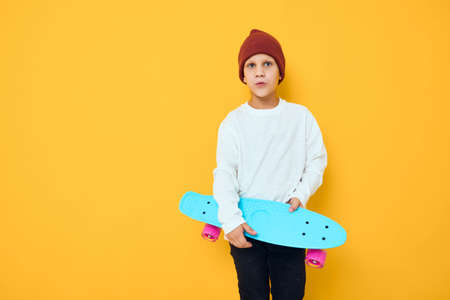 portrait of cute boys casual blue skateboard studio posingの写真素材