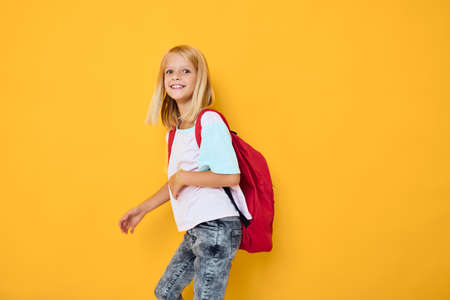 portrait of cute girls stylish clothes red backpack isolated backgroundの写真素材