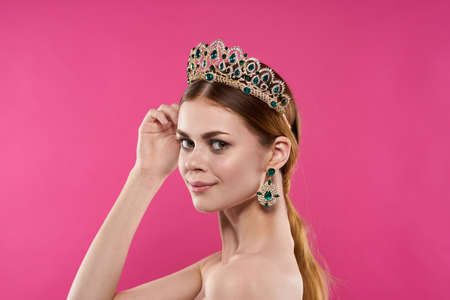 portrait of a woman with a crown on her head makeup decoration isolated backgroundの写真素材