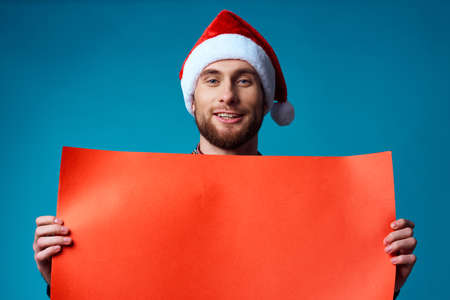 handsome man in a christmas Orange mockup Poster blue backgroundの写真素材