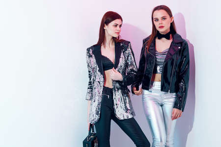 two trendy women in modern style disco clothing