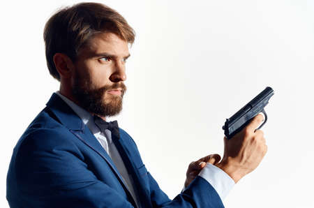 male gangster with a gun in hand Studio emotionsの写真素材