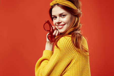 attractive woman with yellow bandage glasses in the hands of Studio accessories
