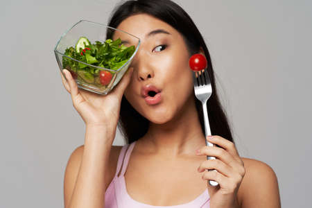 woman of asian appearance plate with salad healthy food vegetables