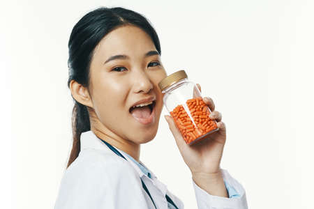 female doctor in white coat pills pharmacist treatmentの写真素材