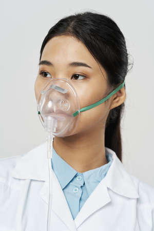 asian woman doctor medicine oxygen mask hospitalの写真素材