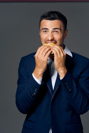 business man wearing hamburger suit snack lifestyleの写真素材