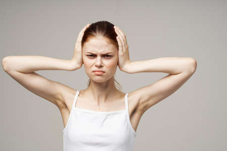 woman ear pain otitis media health problems infection light backgroundの写真素材