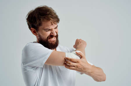 sick man bandaged hand injury to fingers hospitalization light backgroundの写真素材
