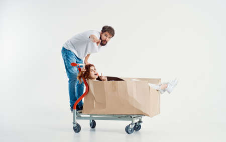 Man and woman shipping transport in a box light backgroundの写真素材