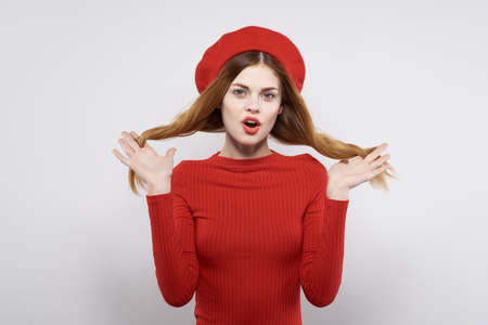 cheerful woman with a red cap on his head glamor light backgroundの写真素材