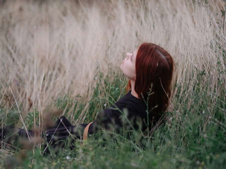 woman in dress lies on the grass nature freedomの写真素材