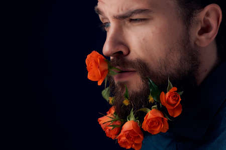 handsome man posing flowers in a beard fashion Lifestyle close-up Studio