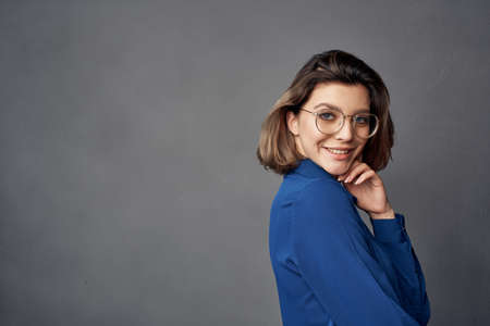 pretty woman with glasses blue shirt fashionの写真素材