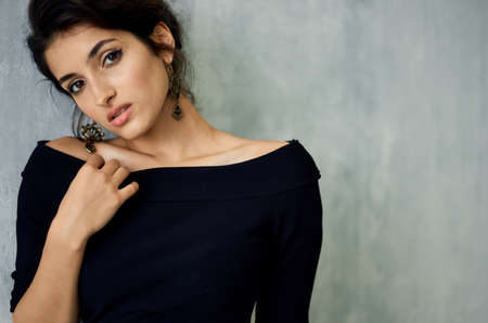 Woman in black dress smile decoration fashion light backgroundの写真素材