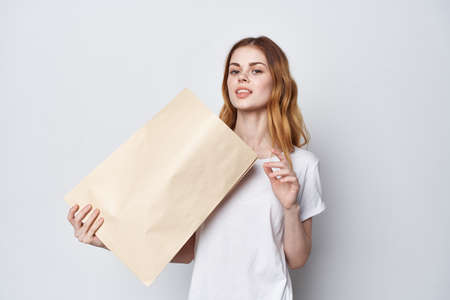 pretty woman in white t-shirt with shopping bag in her handsの写真素材