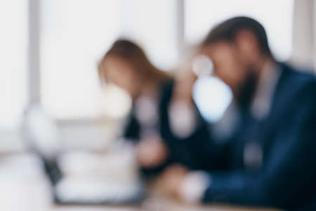 managers sitting at a desk with a laptop communication professionalsの写真素材