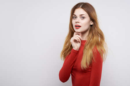 pretty woman fashion hairstyle red sweater model isolated backgroundの写真素材