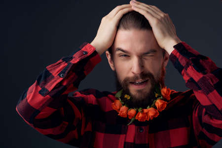 portrait of a man posing flowers in a beard fashion Lifestyle dark backgroundの写真素材